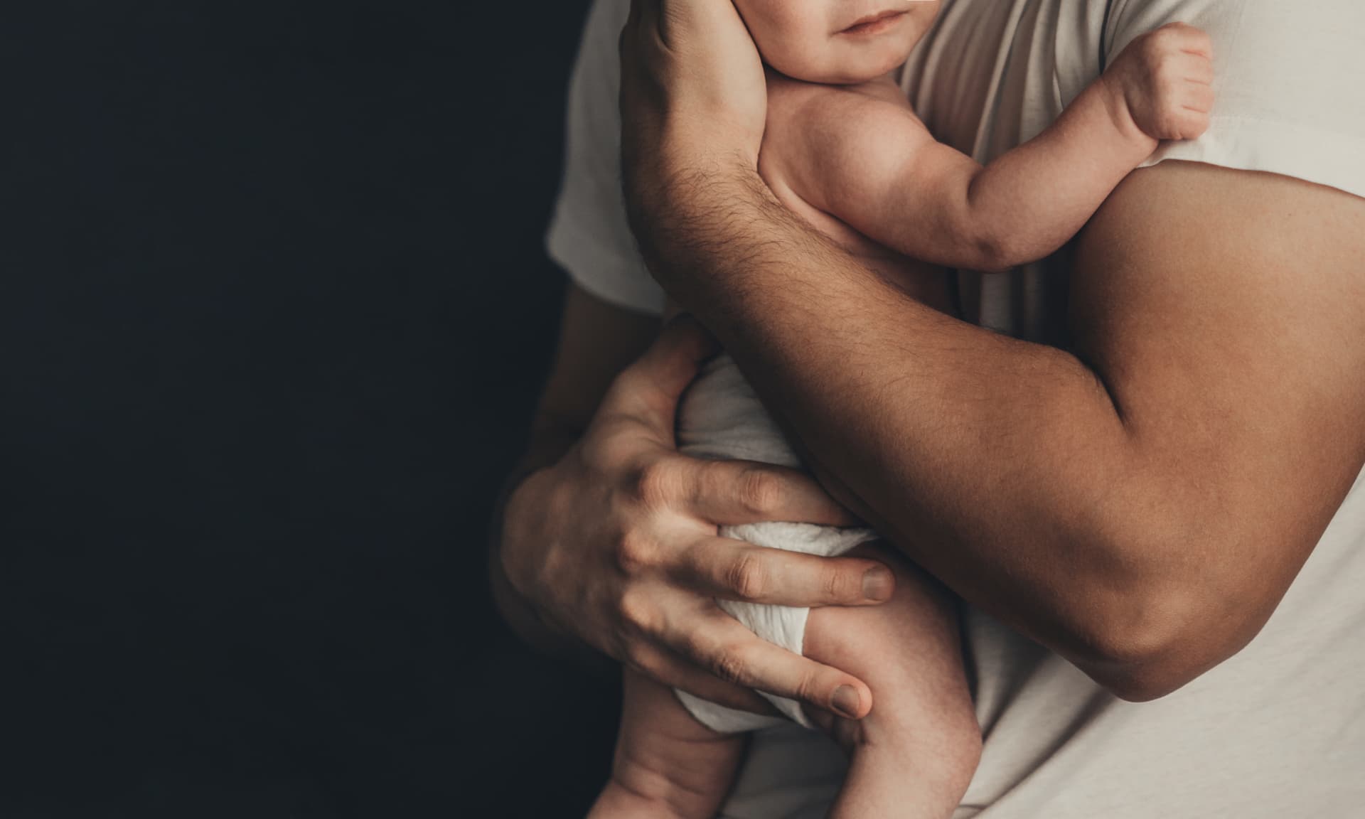 Dad holding a little baby