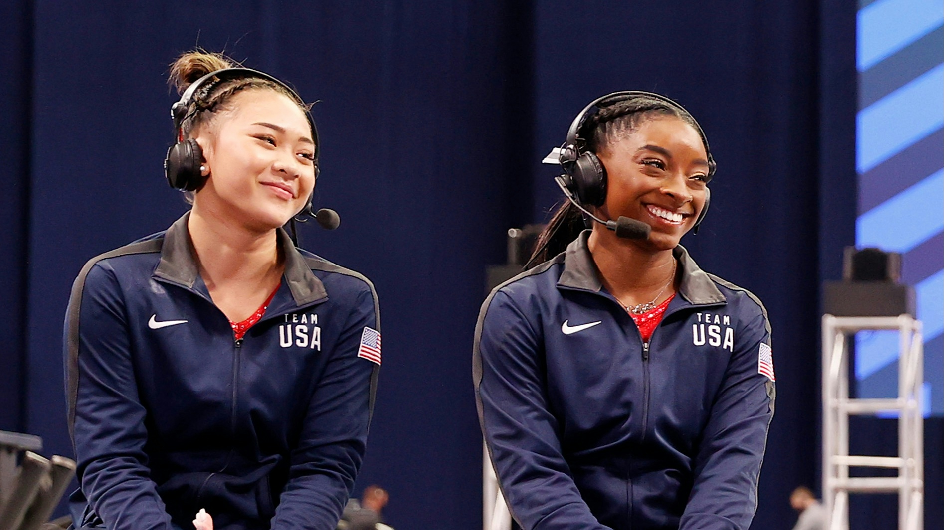 Simone Biles (L) and Sunisa Lee of the United States react during the women's artistic gymnastics team all-around final