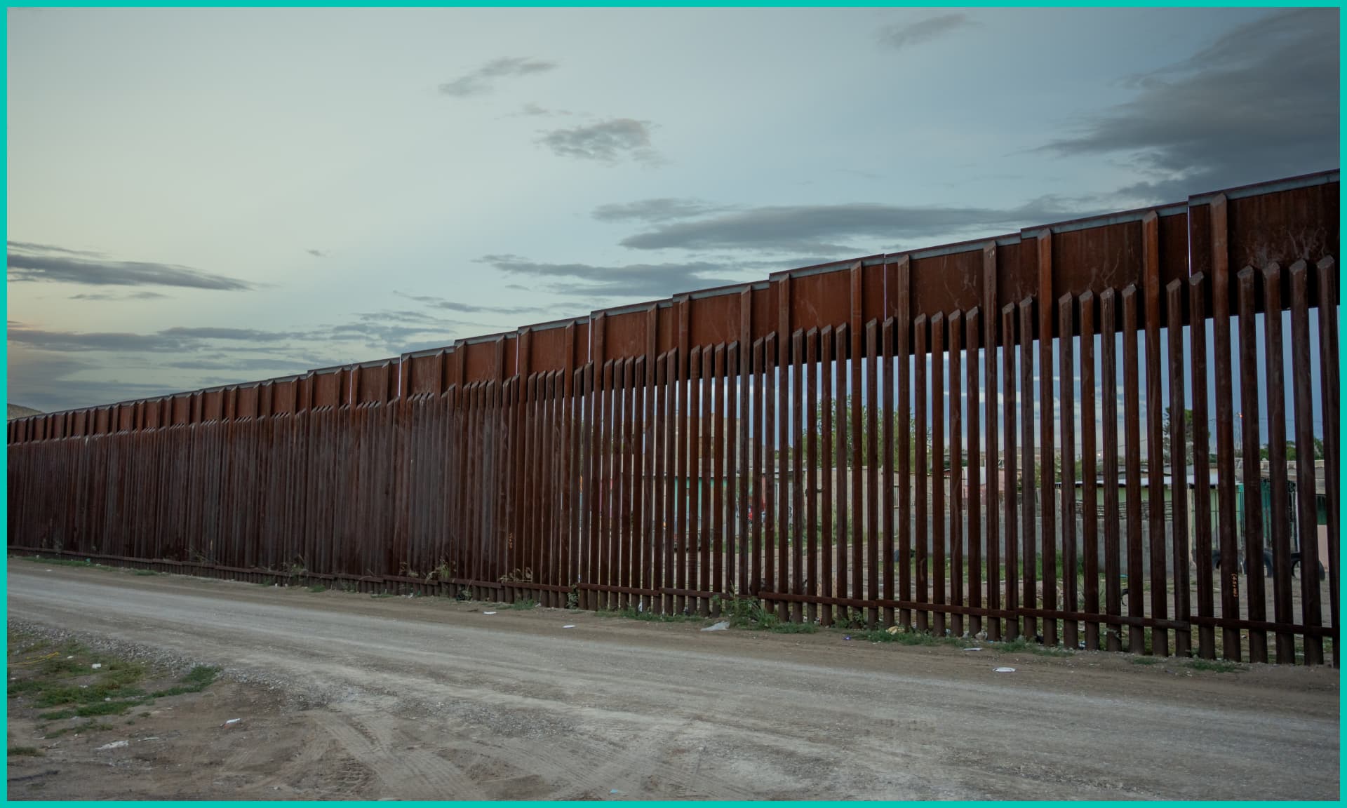 Moody Night Shot of Border Wall Between El Paso Texas USA and Juárez Chihuahua Texas at Puerto Anapra