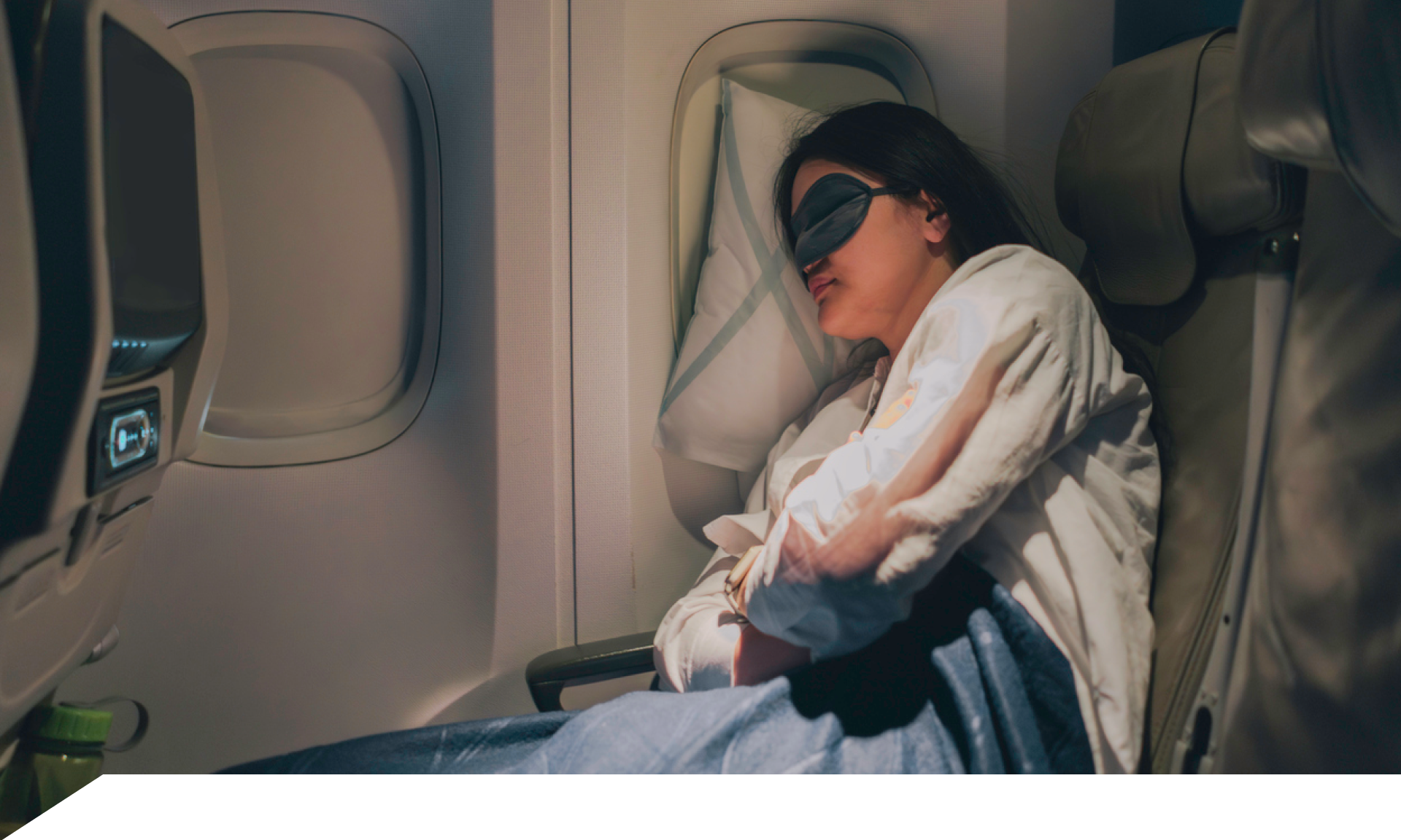 A woman sleeping on a plane