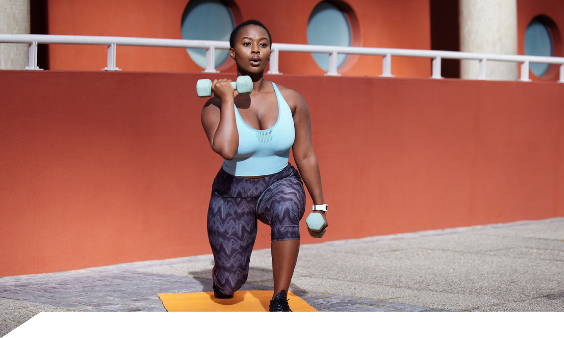 A woman doing a squat on a yoga mat 