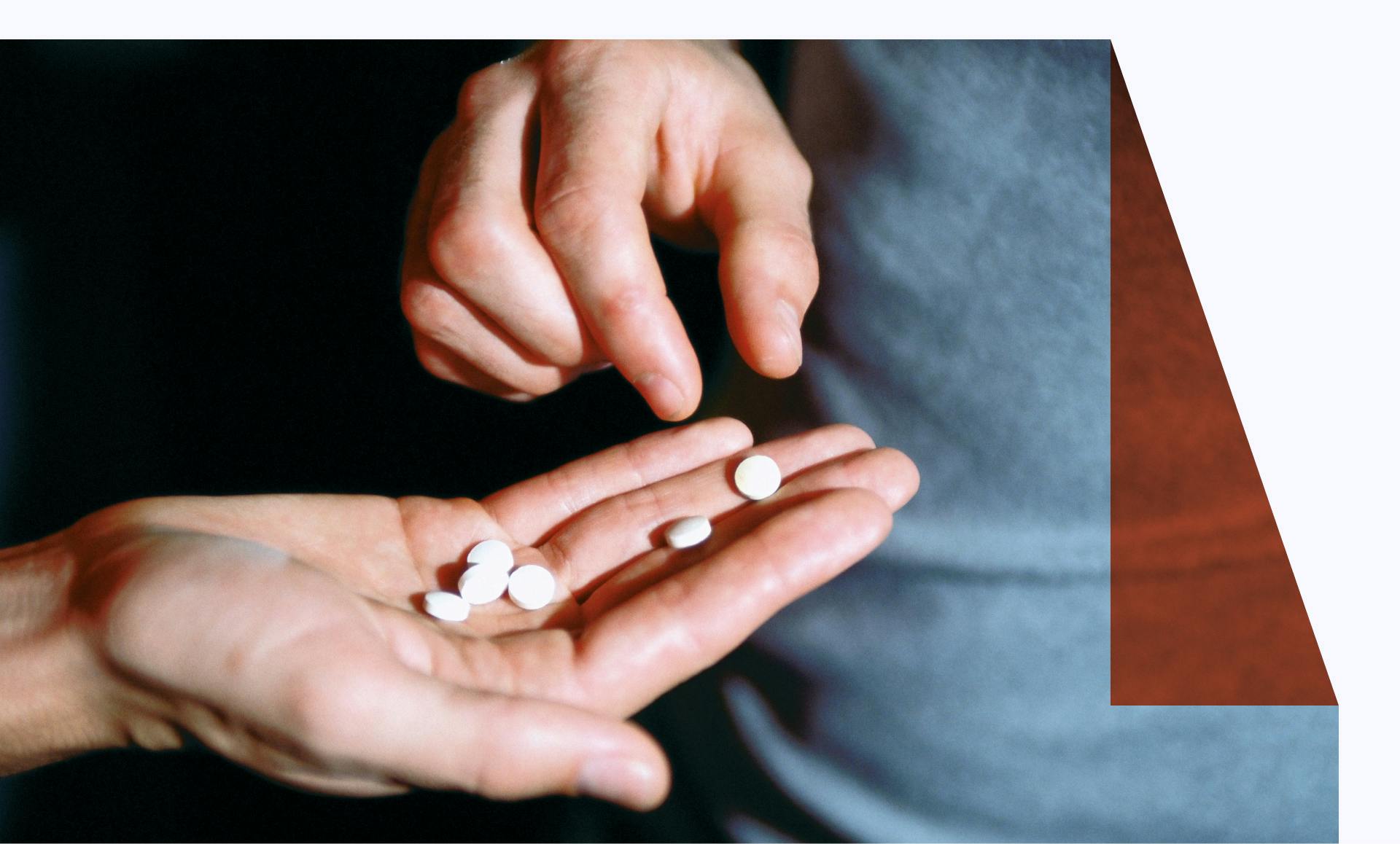 Male hand holding recreational drugs - stock photo
