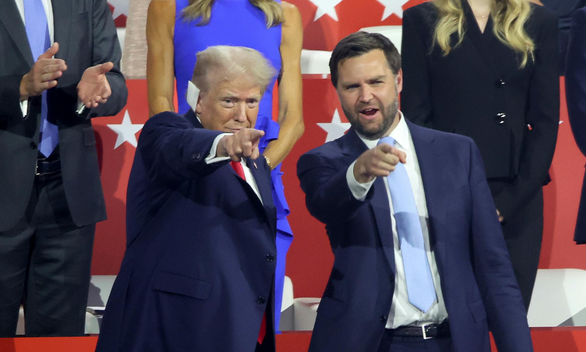 Former US President Donald Trump, left, and J.D. Vance point to the crowd during the first day of the Republican National Convention at Milwaukee, WI