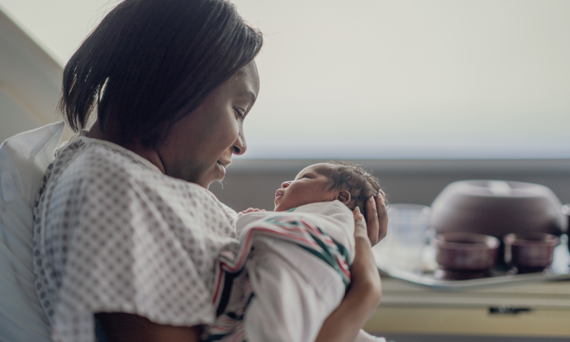 A woman holding her newborn baby