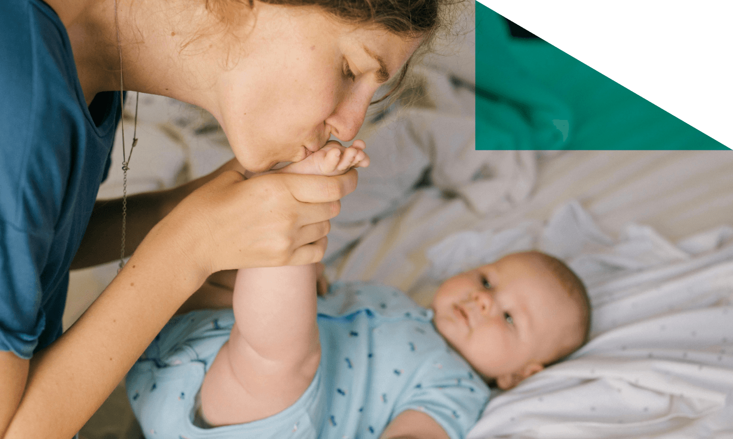 women kissing baby feet