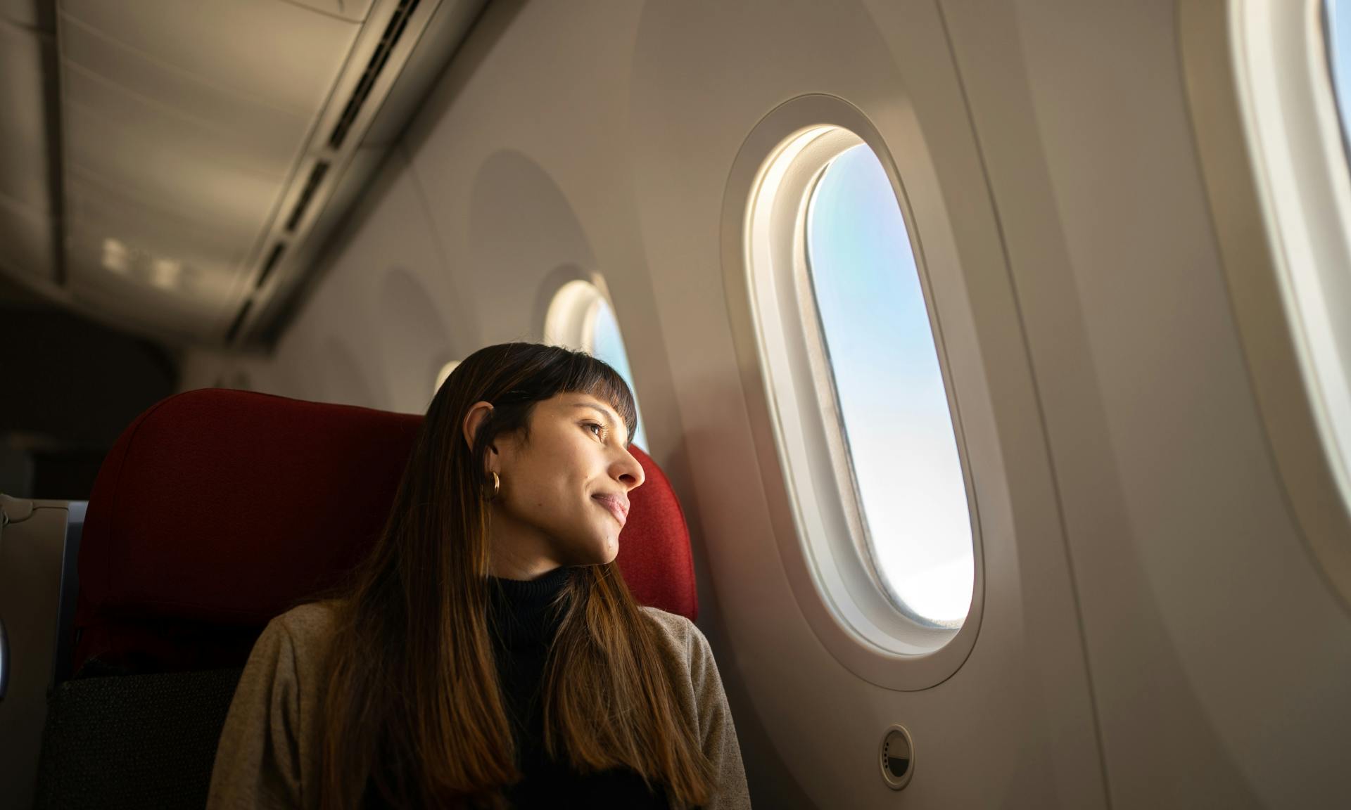 Woman looking out airplane window