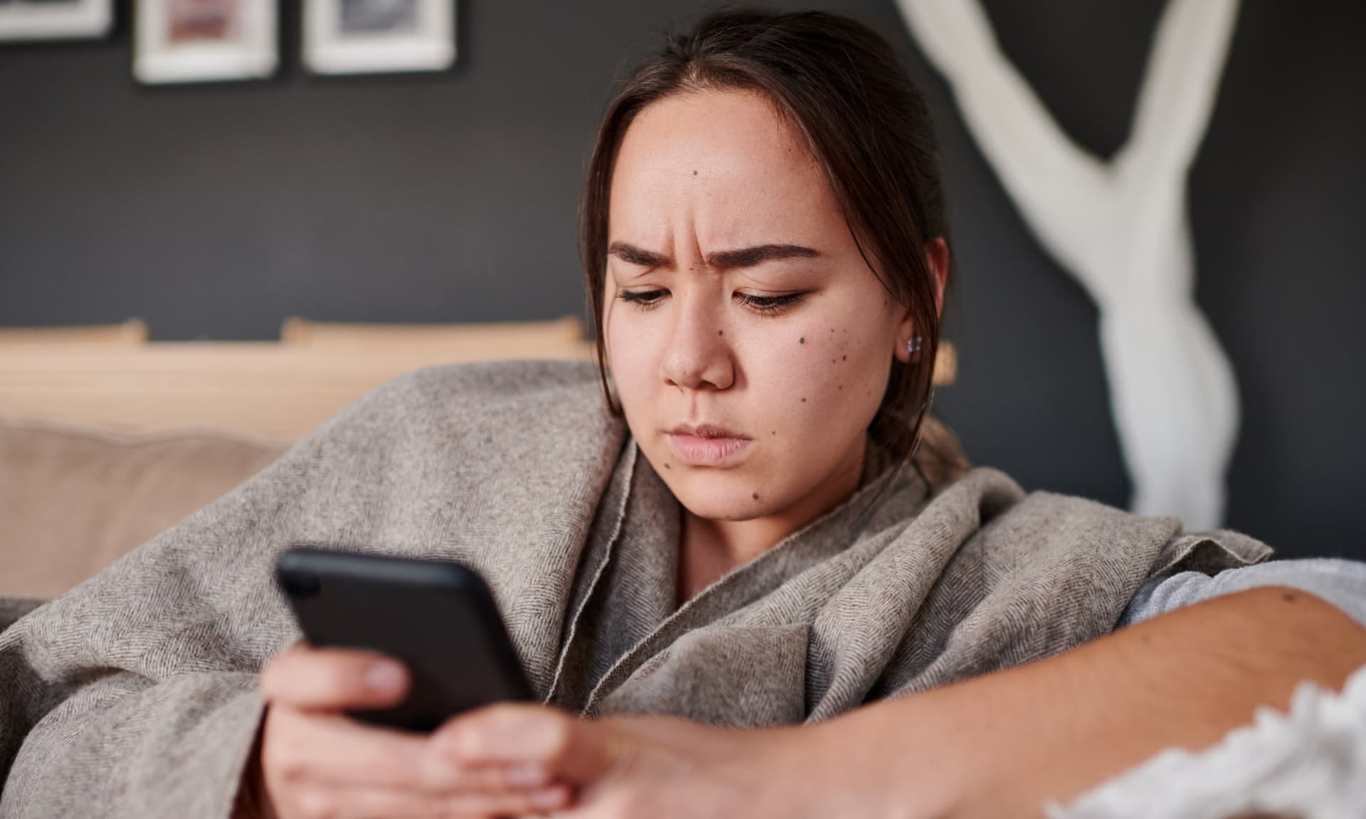 Woman looking mad at phone.