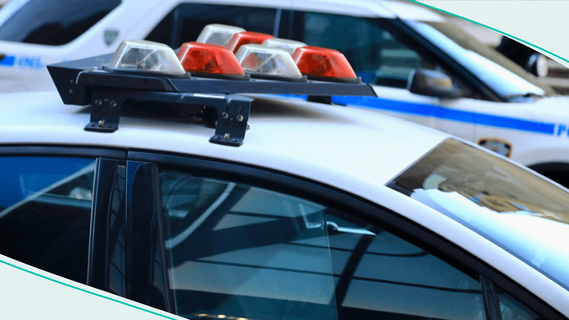 Police vehicles with overhead strobe lights at a crime scene