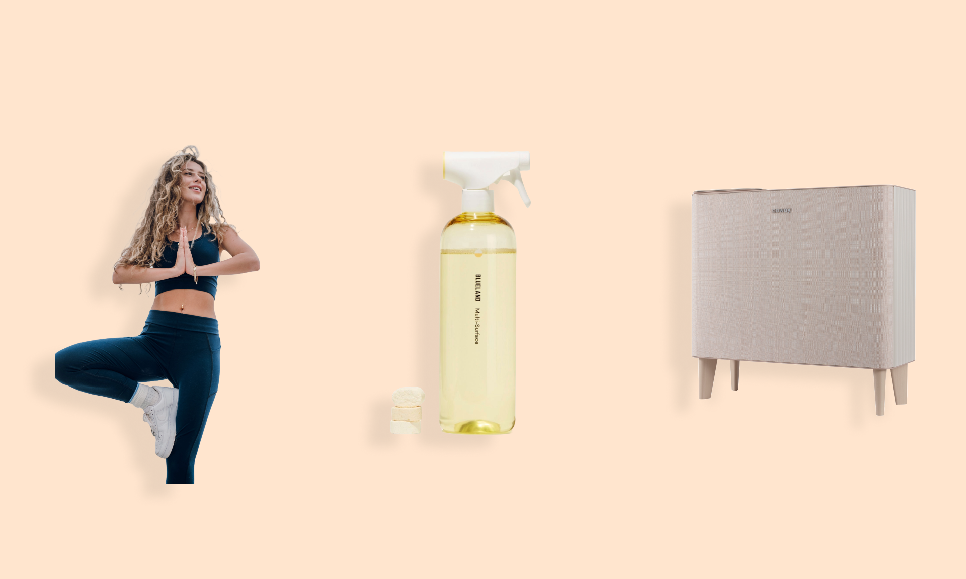 A woman wearing a Reprise matching workout set, a bottle of Blueland cleaning spray, and the Coway Airmega Icon air purified