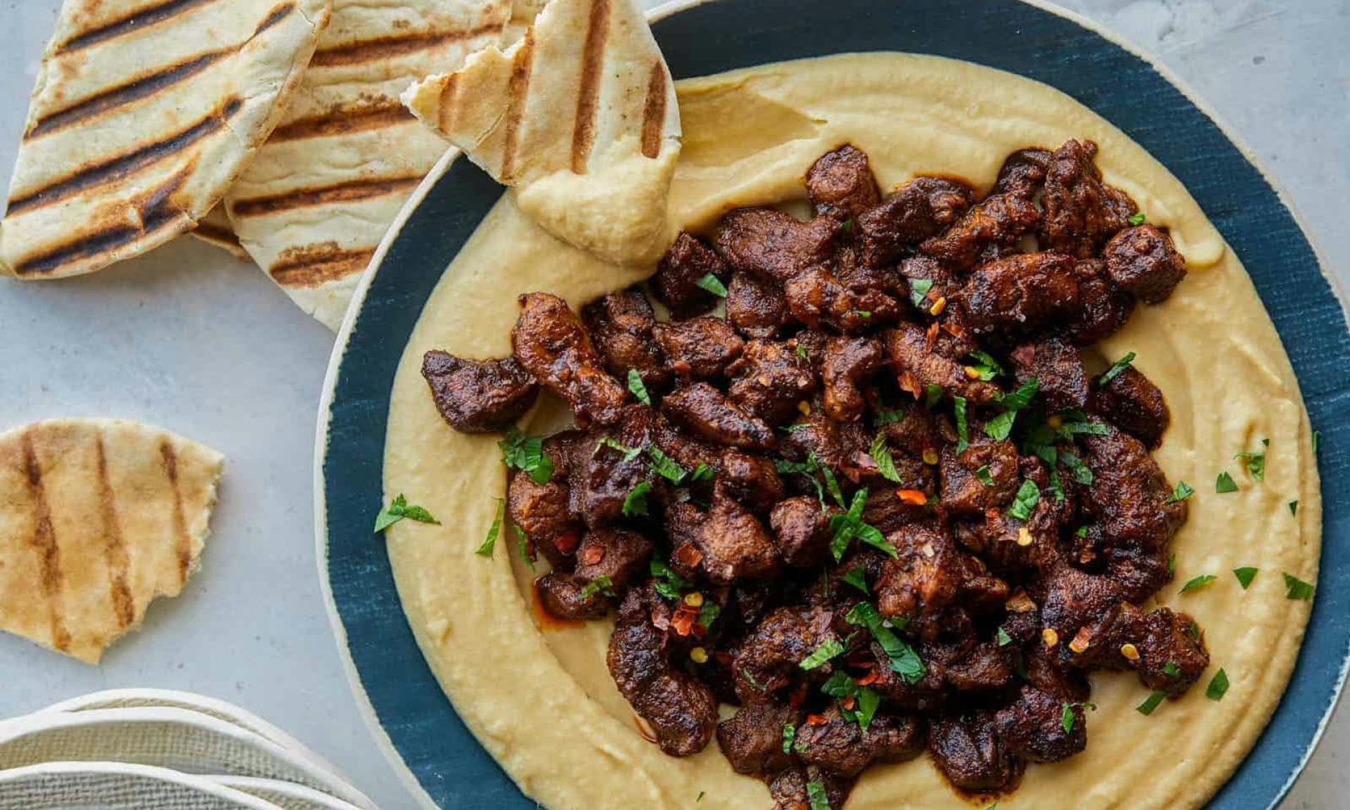 Hummus served with meat and pita