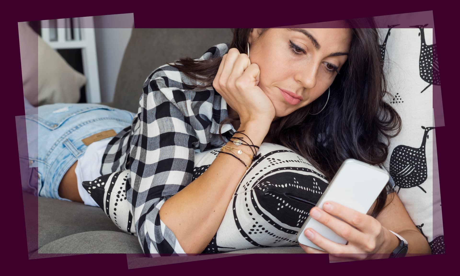 woman scrolling on phone in bed