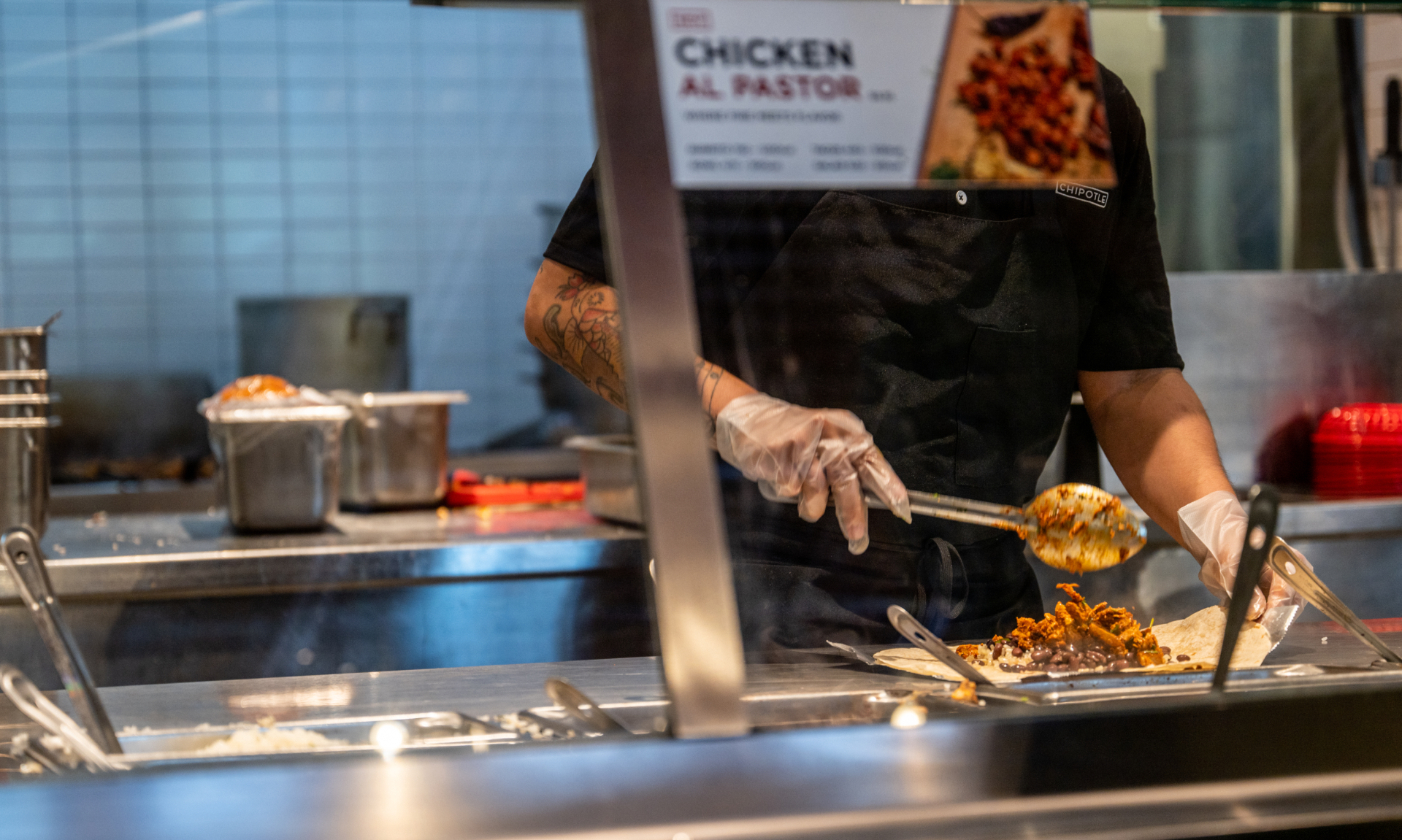 An employee prepares food at a Chipotle Mexican Grill restaurant on April 26, 2023 in Austin, Texas.