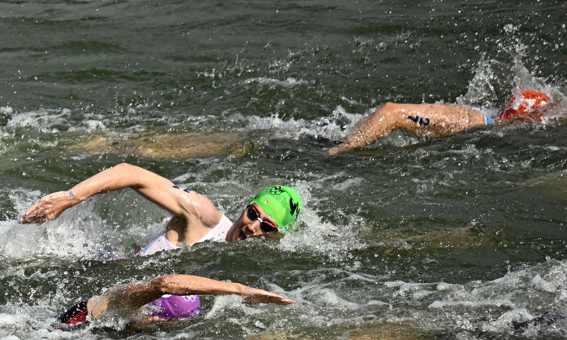 Athletes compete in the swimming stage in the Seine river during the men's individual triathlon at the Paris 2024 Olympic Games in central Paris on July 31, 2024. 