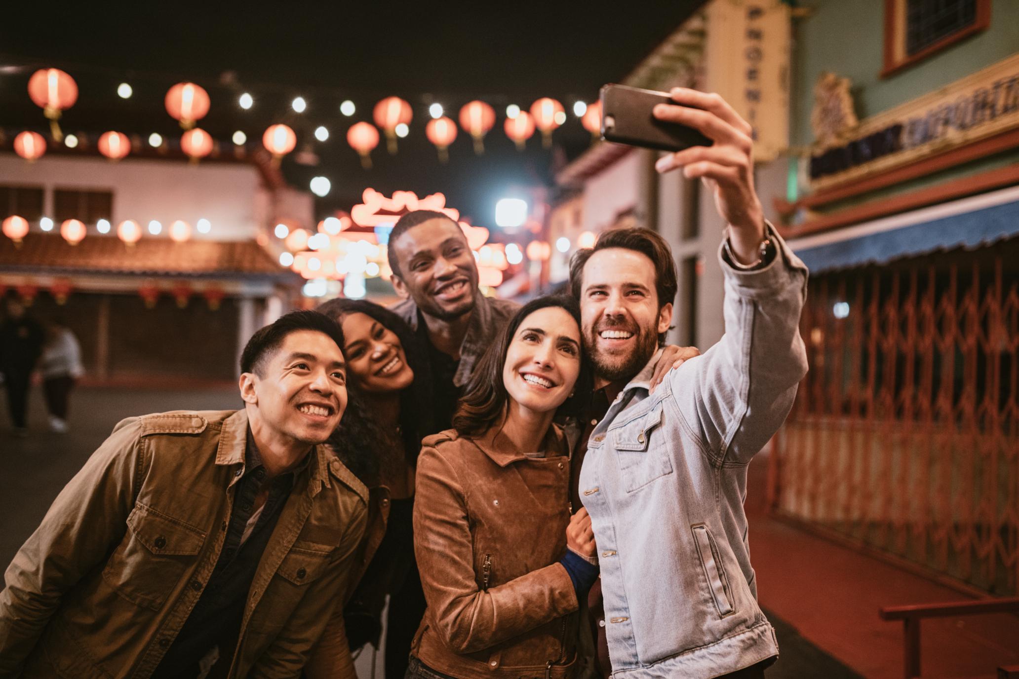 Smiling people taking a selfie.