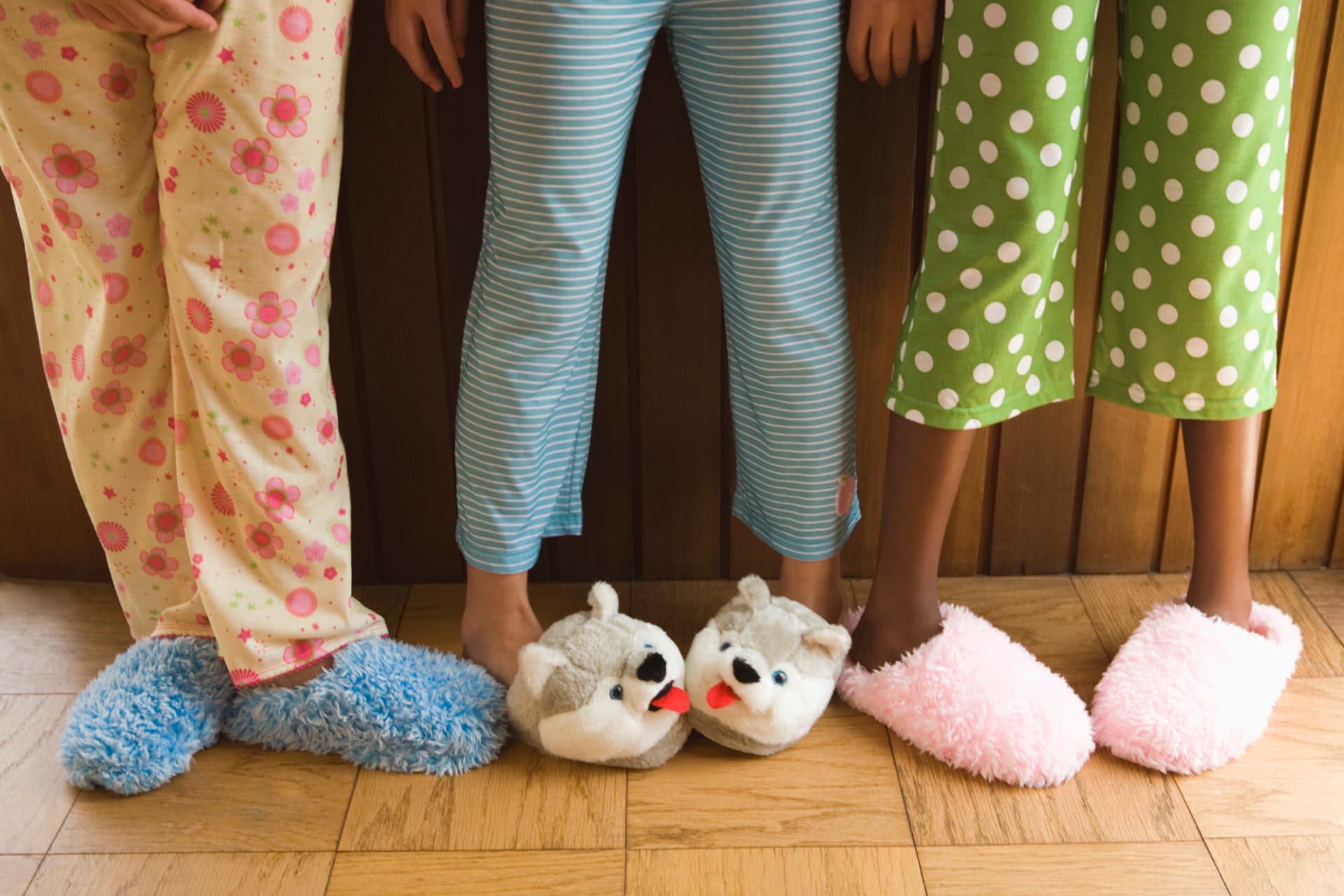 Pre-teen girls wearing fuzzy slippers
