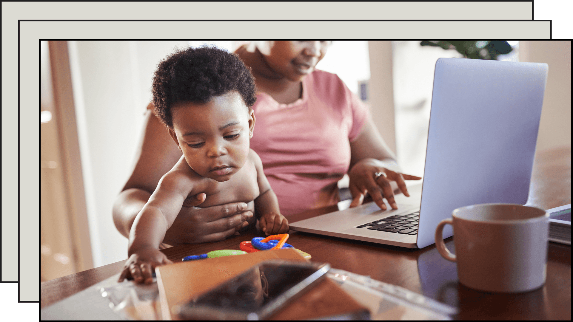 mom on the computer while holding baby
