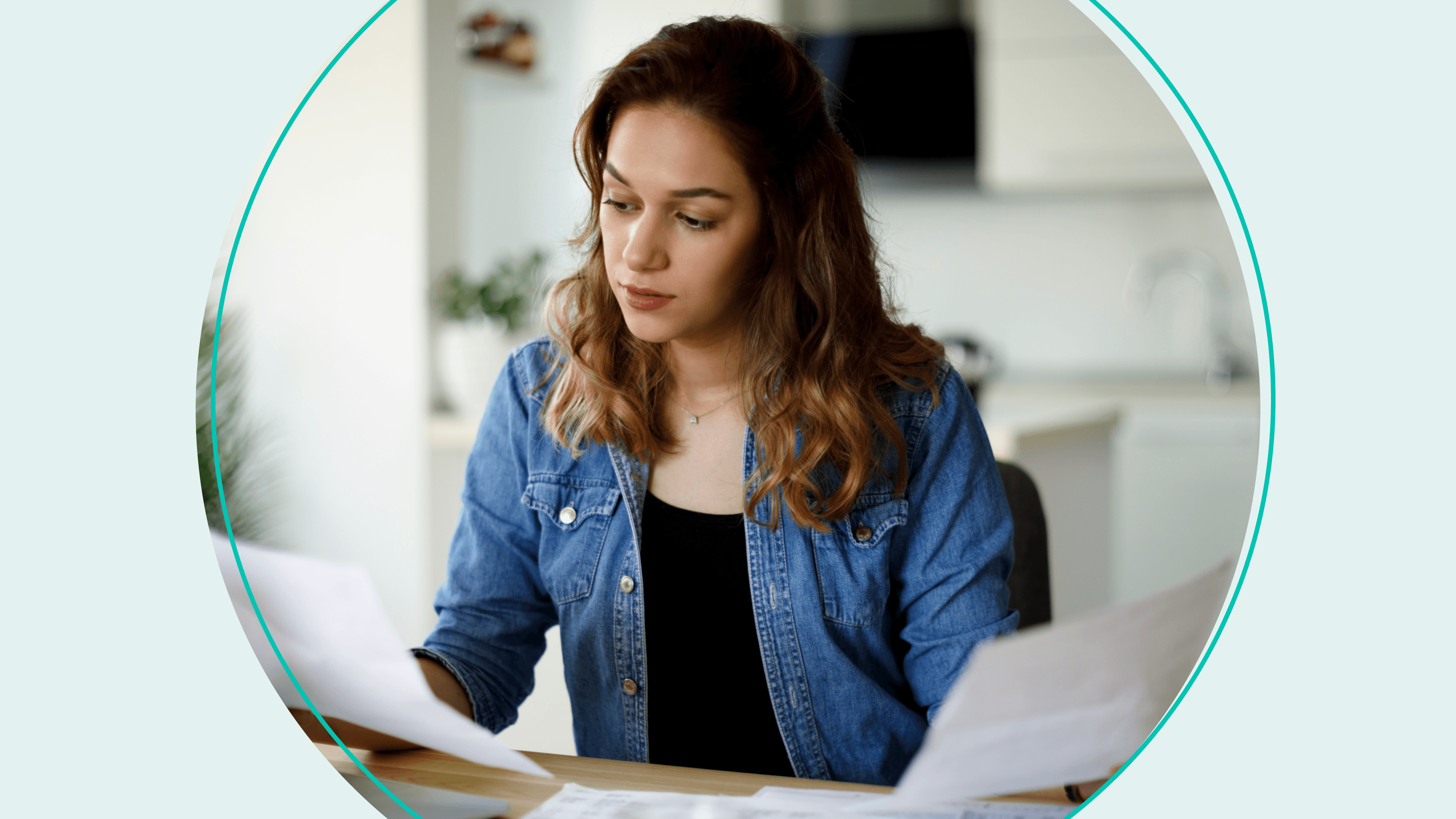 woman looking over papers at desk