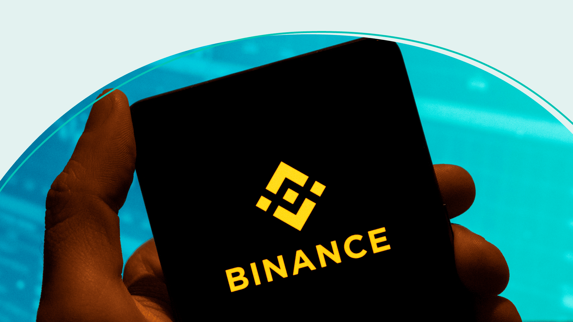 The cryptocurrency exchange trading platform Binance logo is seen displayed on a smartphone with an economic stock exchange index graph in the background.