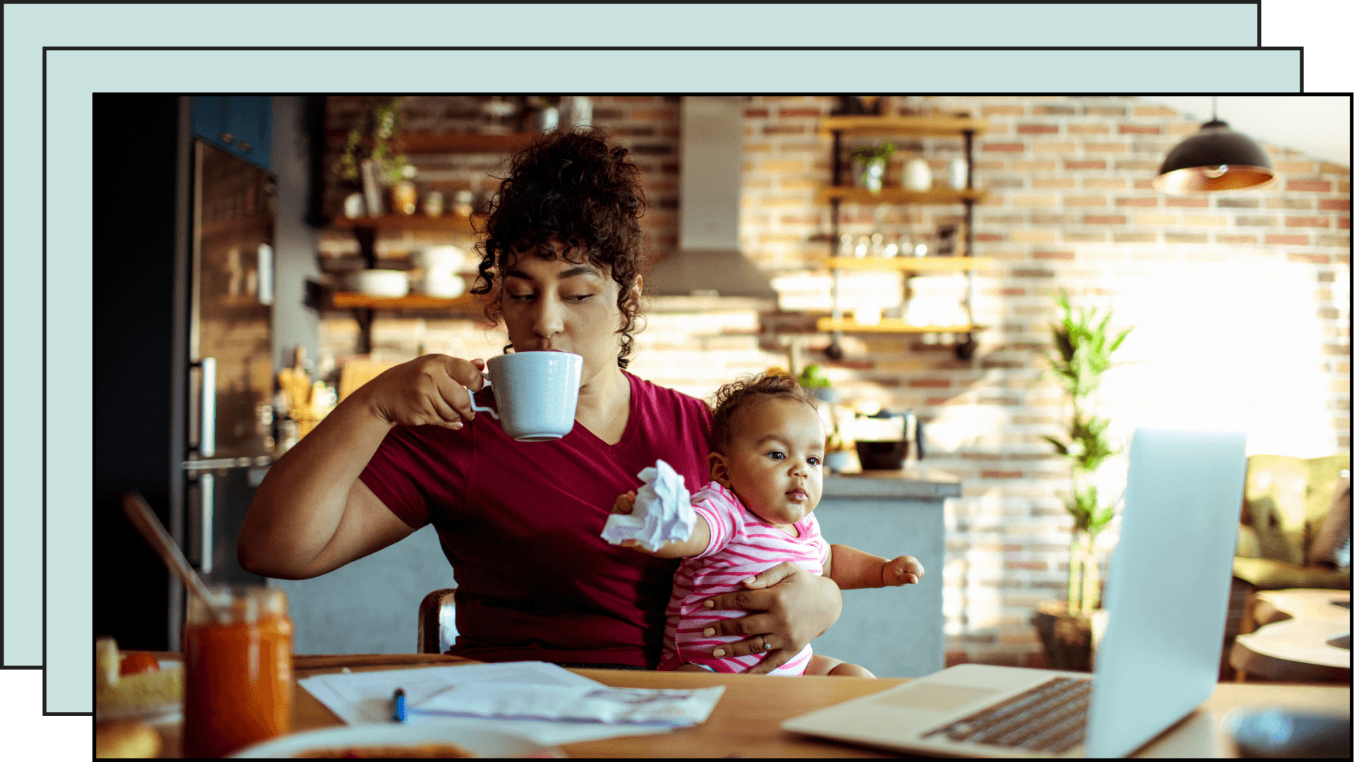mom drinking coffee while holding baby