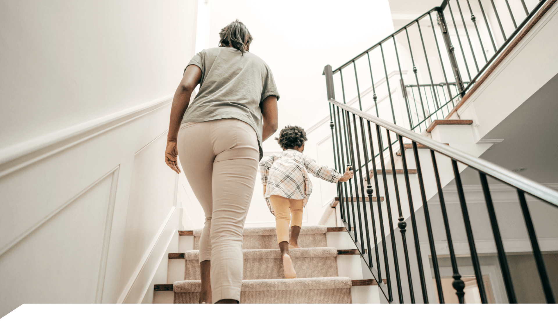 A woman walking up stairs holding a coffee cup